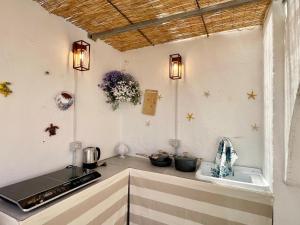a kitchen with a counter with a stove and a sink at Amare Gallipoli in Gallipoli