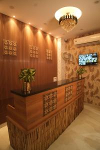 a hotel lobby with a reception desk and a chandelier at Sanidhyam by Hotel Sahu near Temple in Varanasi