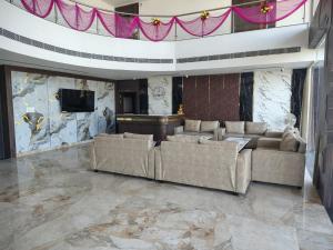 a living room with two couches and a television at Hotel SS Palace in Gaya