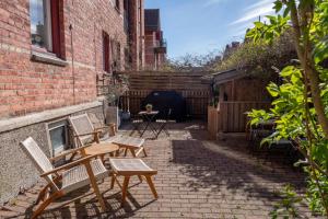 a patio with chairs and a table and a fence at C Apartments Annedal in Gothenburg +57 photos