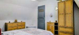 a bedroom with a bed and a blue door at Le Passage Secret in Saint-Omer +6 photos