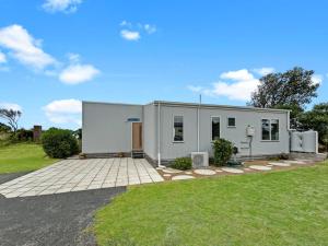 a large white modular home with a driveway at Snapper Cabin in Portland