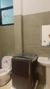 a small bathroom with a toilet and a sink at Ck resort in Weligama
