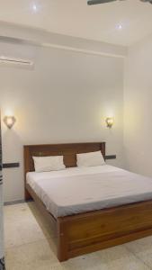 a bedroom with a large bed with white sheets at Ck resort in Weligama