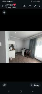a picture of a living room with a table and a chair at Nightingale Guesthouse Randfontein in Randfontein