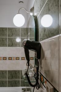 a hair dryer is attached to a wall in a bathroom at Penzion Pod Kašnou in Frýdek-Místek +99 photos