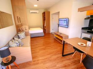 a living room with a couch and a table and a television at ibis Styles Bonito in Bonito