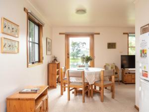 a kitchen and dining room with a table and chairs at Whalers Cottage in Port Fairy