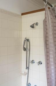 a shower in a bathroom with a shower curtain at Whalers Cottage in Port Fairy +22 photos