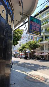 a sign for a drugstore dancing dealer on a city street at KS Phương Danh in Quy Nhon