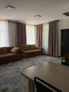 a living room with couches and a table at Rest House in Cholpon-Ata +3 photos