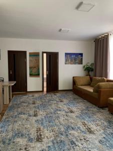 a living room with a couch and a rug at Rest House in Cholpon-Ata