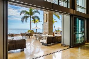an open lobby with a view of the ocean at Hyatt Regency Trinidad in Port-of-Spain