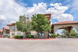 a building with a tree in front of it at Quality Inn & Suites Gallup I-40 Exit 20 in Gallup