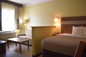 a hotel room with a bed and a couch at Quality Inn & Suites Gallup I-40 Exit 20 in Gallup +60 photos