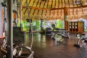 a gym with treadmills and chairs in a room at Thompson Zihuatanejo, A Beach Resort, by Hyatt in Zihuatanejo