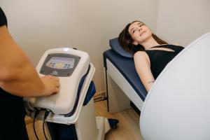 a woman is in a hospital bed with a scale at HOTEL CRYSTAL WELLNESS & SPA superior in Sovata