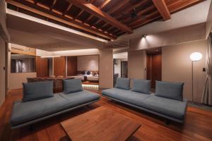 a living room with couches and a dining room at Villa Azure Mira in Miyakojima