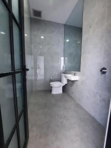 a bathroom with a toilet and a sink and a mirror at Poshaka Karimunjawa in Karimunjawa