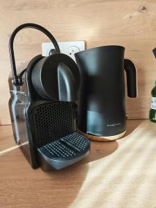 a black coffee mug sitting on top of a table at l'alcôve in Frontignan +3 photos