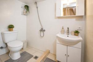 a bathroom with a toilet and a sink at Pandora Stone Cottage Elos in Élos