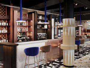 a bar in a restaurant with blue stools at TRIBE PARIS SURESNES in Suresnes