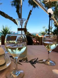 two glasses of white wine sitting on a table at Kato Stalos Mare in Stalos