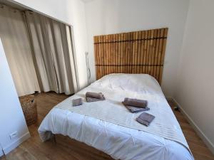 a bedroom with a bed with two pillows on it at l'alcôve in Frontignan