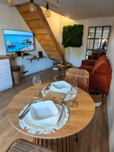 a dining room table with white plates and wine glasses at l'alcôve in Frontignan