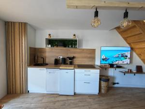 a kitchen with white cabinets and a counter top at l'alcôve in Frontignan