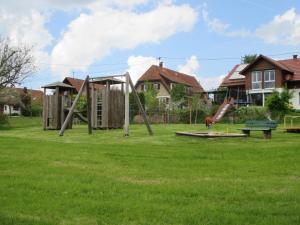 a playground with a swing set in a yard at Black Forest Lodge in Freudenstadt