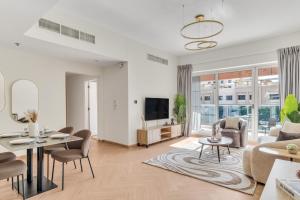 a living room with a couch and a table at Stella Stays Barsha Heights in Dubai