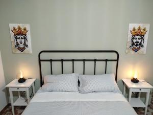 a bedroom with a bed with two nightstands and two lamps at Orto dei Frati in Sortino