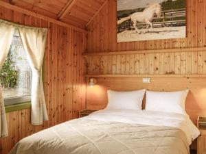 a bedroom with a bed and a horse painting on the wall at ISSA Village in Turda