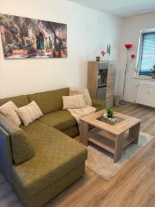 a living room with a couch and a coffee table at Thermal Oazis Apartman in Mosonmagyaróvár