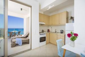a kitchen and dining room with a view of the ocean at SEPERI Deep Blue in Rethymno