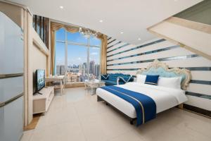 a bedroom with a blue and white striped wall at Louidon Mega Duplex Apartment - Beijing Rd in Guangzhou