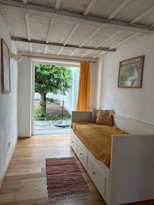 a bedroom with a bed and a large window at Domek u vína in Perná