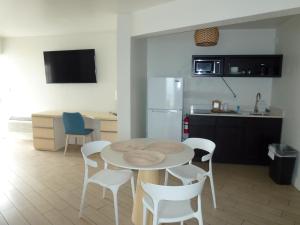 a kitchen with a table and chairs in a room at Chateau Mar Beach Hotel NEWLY REFURBISHED in Ormond Beach