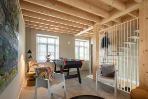 a living room with a piano and a table at Entre Pierres et Rivière - 2 Gites avec wellness privatifs in Hotton