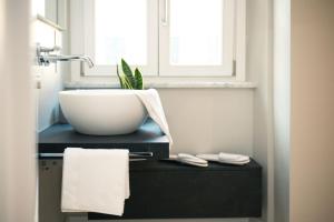 a bathroom with a bowl sink and a window at Anfiteatro - Spacious and elegant residence in Lucca +2 photos