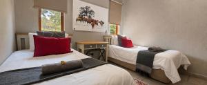 a room with two beds with red pillows at 26 on Greenway in White River +23 photos