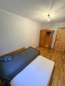 a bedroom with a bed and a wooden floor at Pine Apartment, Riga in Riga