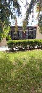 a house with a yard in front of a building at Marathon Βeach Ηouse in Panayía Mesosporítissa