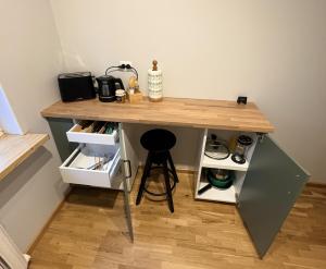 a desk with a stool under it in a room at Pine Apartment, Riga in Riga