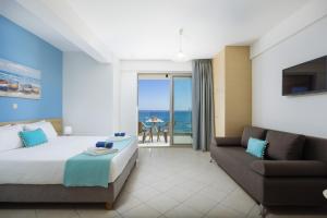 a hotel room with a bed and a couch at SEPERI Deep Blue in Rethymno