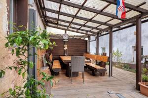 an outdoor patio with a wooden table and chairs at Am Fabianstift 1 in Hornbach