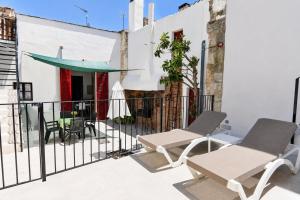 a patio with chairs and a table on a balcony at 229 Casa Es Forn ETV10429 by Mallorca Charme in Petra