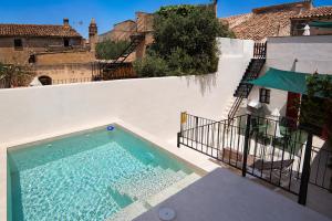 a swimming pool on the side of a building at 229 Casa Es Forn ETV10429 by Mallorca Charme in Petra