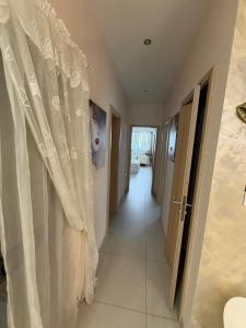 a hallway with white curtains in a house at S'Agapo Maisonette St' Julians in St. Julianʼs